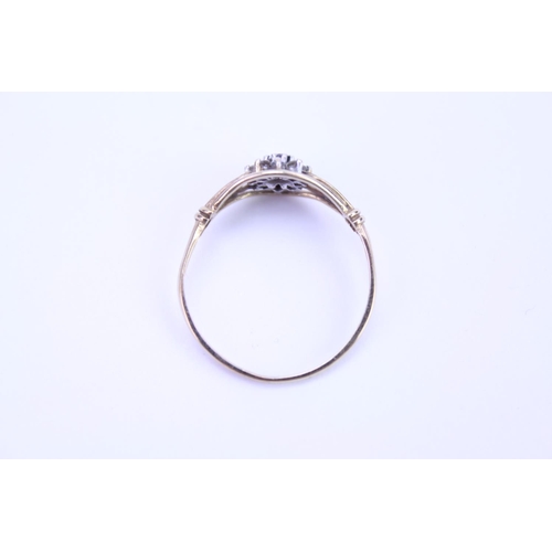 106 - A 9ct Gold dress ring set with a single Sapphire, surround set with paste. Size approx Q.