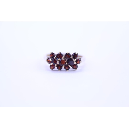 109 - A ladies 9ct Gold dress ring set with garnets in the shape of flowers. Size approx P.