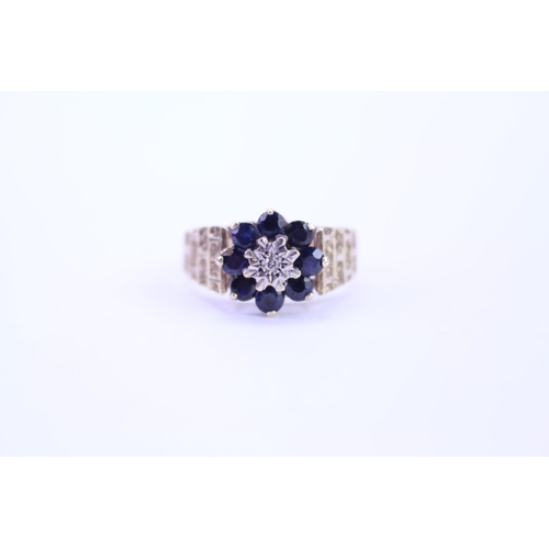 114 - A ladies 9ct Gold dress ring set with Sapphires and Diamonds, with granulated shoulders. Size approx... 