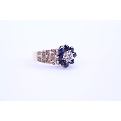 114 - A ladies 9ct Gold dress ring set with Sapphires and Diamonds, with granulated shoulders. Size approx... 