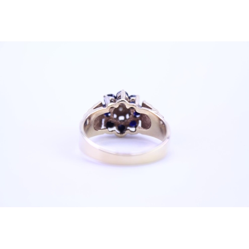 114 - A ladies 9ct Gold dress ring set with Sapphires and Diamonds, with granulated shoulders. Size approx... 