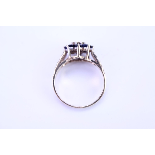 114 - A ladies 9ct Gold dress ring set with Sapphires and Diamonds, with granulated shoulders. Size approx... 