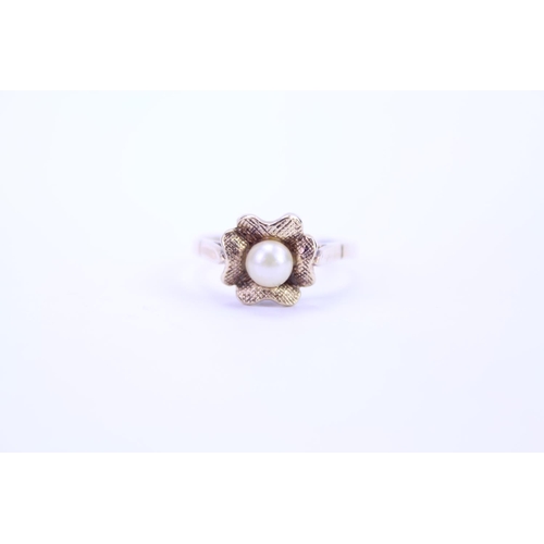 116 - A ladies 9ct Gold dress ring set with a centre 'pearl'. Size is approx M.