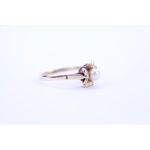 116 - A ladies 9ct Gold dress ring set with a centre 'pearl'. Size is approx M.