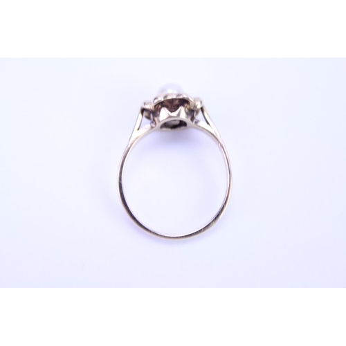 116 - A ladies 9ct Gold dress ring set with a centre 'pearl'. Size is approx M.