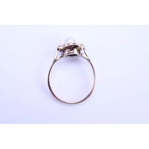 116 - A ladies 9ct Gold dress ring set with a centre 'pearl'. Size is approx M.