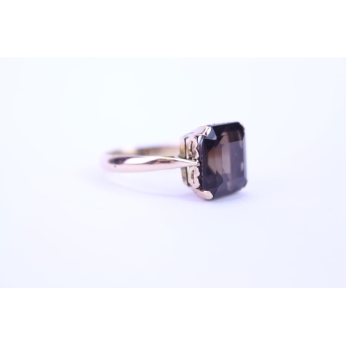 118 - A 14k Gold dress ring set with a continental Smokey quartz. Size approx Q.