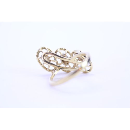 127 - An 18ct yellow Gold dress ring in oval section, highlighted with white gold. Size approx M.