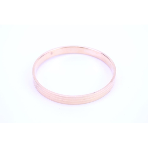 96 - A ladies 15ct Gold slave bangle with engraved decoration. Weight approx 18 grams.