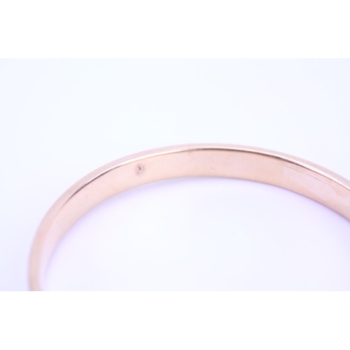 96 - A ladies 15ct Gold slave bangle with engraved decoration. Weight approx 18 grams.