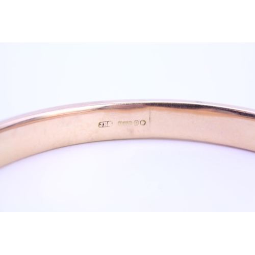 96 - A ladies 15ct Gold slave bangle with engraved decoration. Weight approx 18 grams.