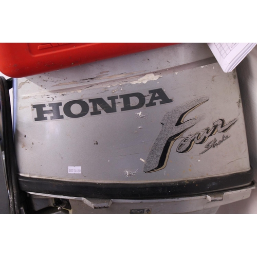 573 - A 1990s Honda 9.9 Four Stroke Outboard Motor with Separate Fuel Tank & Owners Manual. (Not Tested).