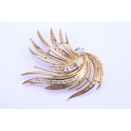 147 - An 18ct Gold Diamond spray brooch, set with three old cut Diamonds, along with 34 small Diamonds. Th... 