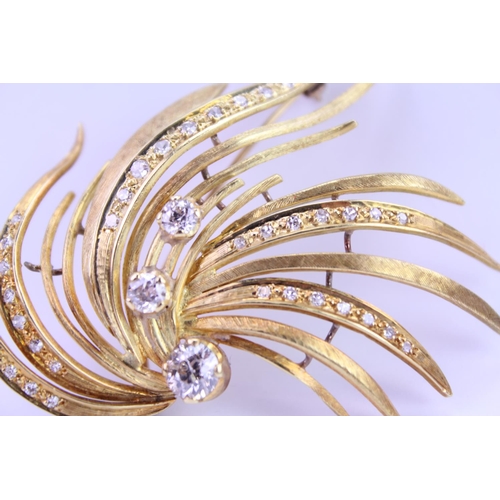 147 - An 18ct Gold Diamond spray brooch, set with three old cut Diamonds, along with 34 small Diamonds. Th... 