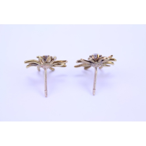 148 - A Pair of Gold French design floral Diamond set earrings. Diamond size approximately 0.25. Total gro... 