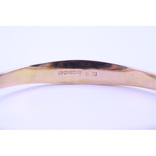 169 - A Ladies 9ct Gold Bangle. Weighing: 6 Grams. Along with a Silver Bangle.