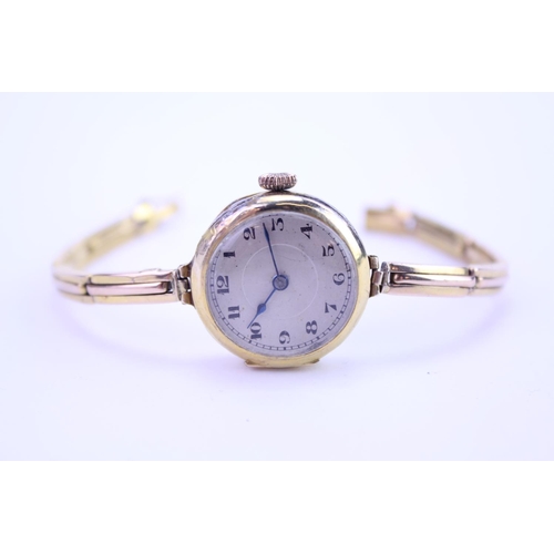 207 - A Ladies 9ct Gold Wristwatch with a nickel front, black numeral's, makers mark: GS3636.