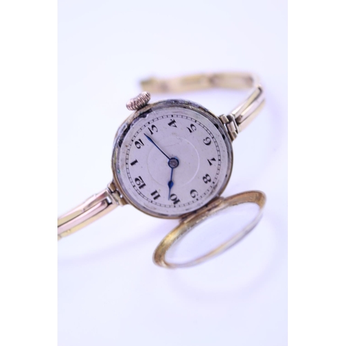 207 - A Ladies 9ct Gold Wristwatch with a nickel front, black numeral's, makers mark: GS3636.