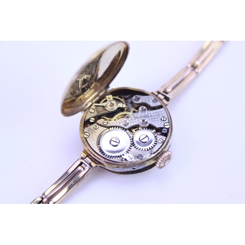 207 - A Ladies 9ct Gold Wristwatch with a nickel front, black numeral's, makers mark: GS3636.