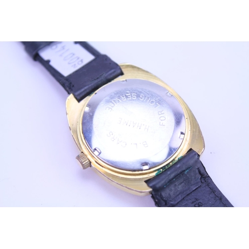 208 - A Garrard Automatic Gold Coloured Wristwatch with day/date, Gold coloured face and black leather str... 