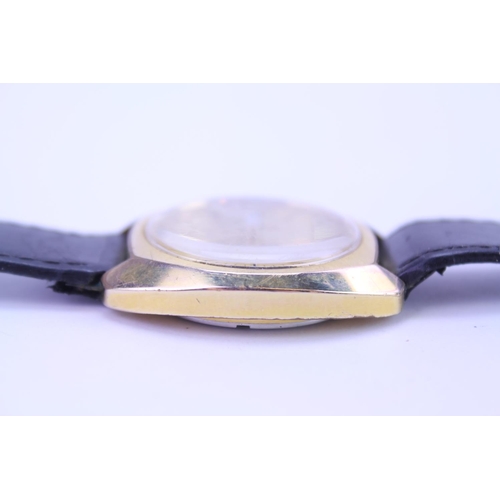 208 - A Garrard Automatic Gold Coloured Wristwatch with day/date, Gold coloured face and black leather str... 