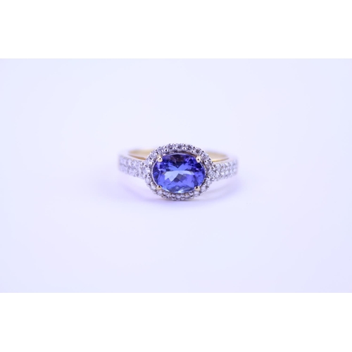 158 - A 750 marked Tanzanite Ring set with Diamonds and a large Tanzanite. Ring size: approx N. Total weig... 