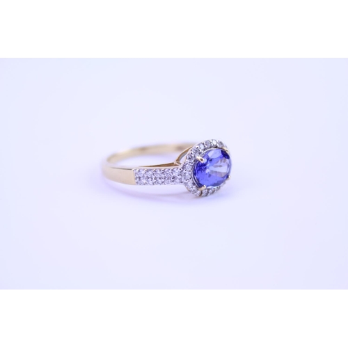 158 - A 750 marked Tanzanite Ring set with Diamonds and a large Tanzanite. Ring size: approx N. Total weig... 