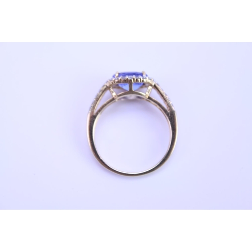 158 - A 750 marked Tanzanite Ring set with Diamonds and a large Tanzanite. Ring size: approx N. Total weig... 