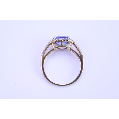 158 - A 750 marked Tanzanite Ring set with Diamonds and a large Tanzanite. Ring size: approx N. Total weig... 