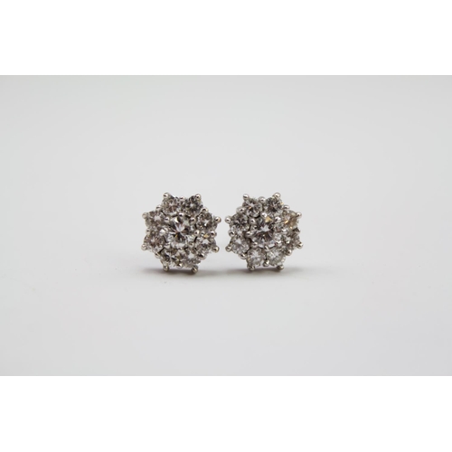 182 - A pair of ladies diamond floral earrings, mounted in 18 carat white gold. Weight approximately 3.3g.... 