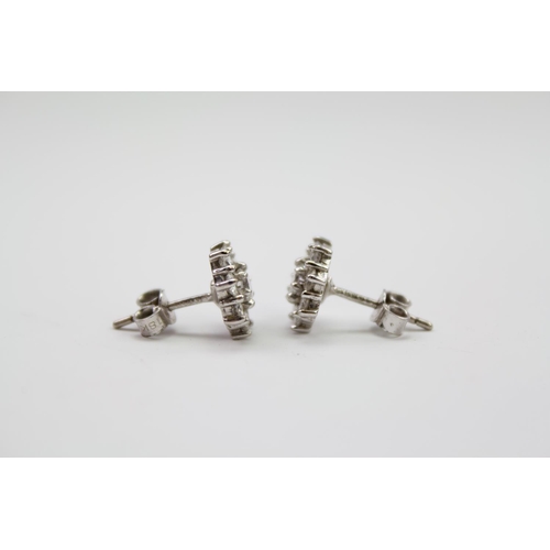 182 - A pair of ladies diamond floral earrings, mounted in 18 carat white gold. Weight approximately 3.3g.... 