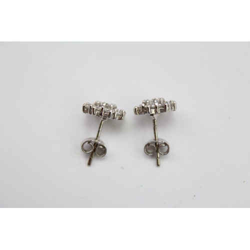 182 - A pair of ladies diamond floral earrings, mounted in 18 carat white gold. Weight approximately 3.3g.... 