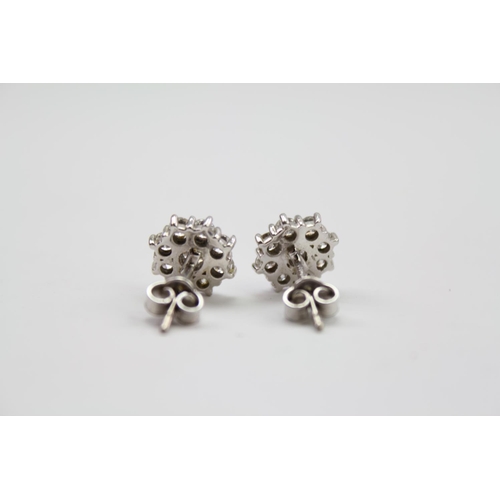 182 - A pair of ladies diamond floral earrings, mounted in 18 carat white gold. Weight approximately 3.3g.... 