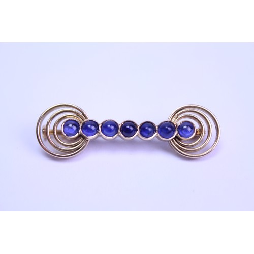 103 - A 9ct Gold brooch, mounted with 7 blue sphere shaped stones. Total weight approx 6.1g. Size approx 4... 