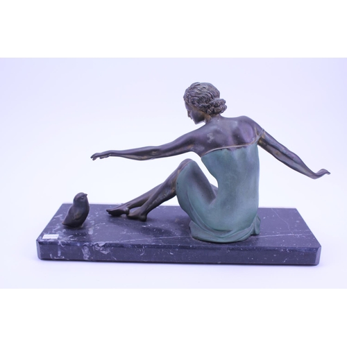 406 - A French Spelter Study an Art Deco Young Lady feeding a Bird on a Banded Marble Base. Measuring 40cm... 