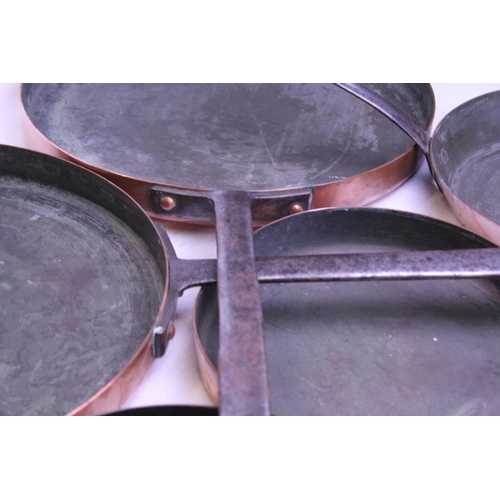 408 - A Graduated Set of Copper & Wrought Iron Handled Frying Pans. (5 in Total).