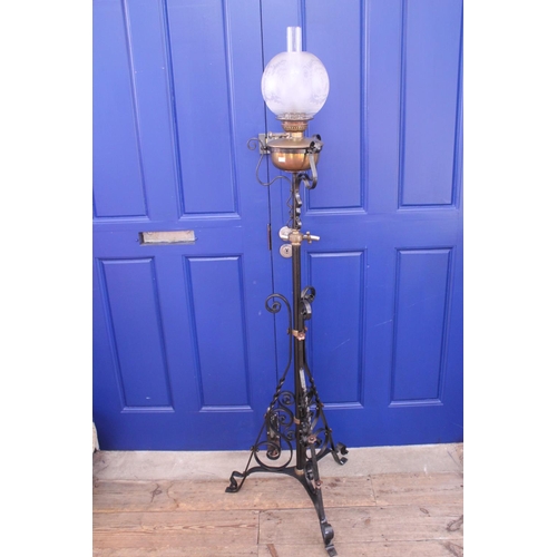 394 - A Wrought iron and Brass mounted oil lamp with Funnel and Shade.