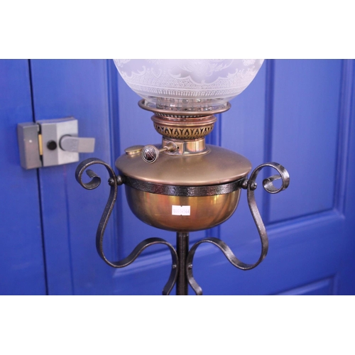 394 - A Wrought iron and Brass mounted oil lamp with Funnel and Shade.