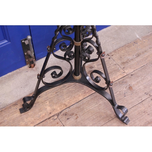 394 - A Wrought iron and Brass mounted oil lamp with Funnel and Shade.