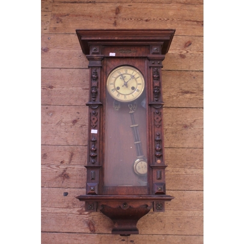 284 - A Late 19th Century Viennese Carved Fronted Wall Clock with Celluloid Dial.