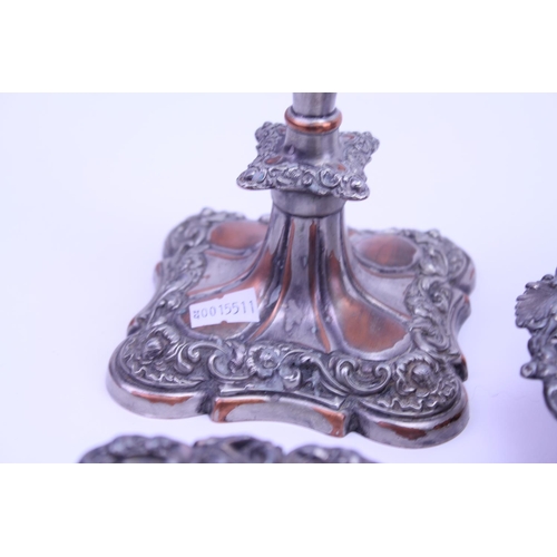 66 - Three Silver Plate on Copper Coasters along with a pair of Silver Plate on Copper Candlesticks.