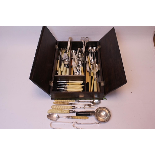 79 - A fold over topped cutlery box containing Victorian and later Silver plated cutlery including a tea ... 