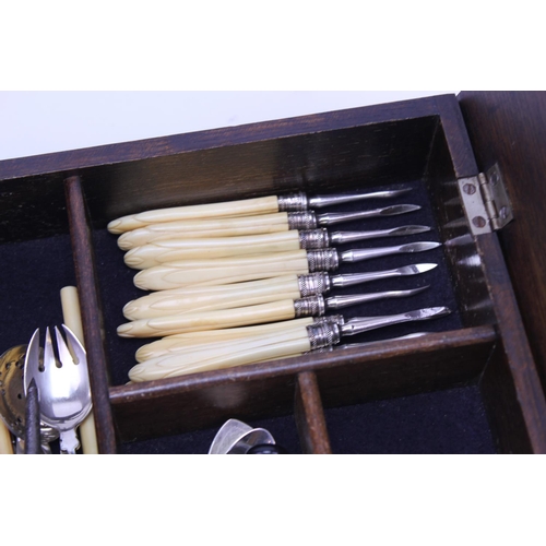 79 - A fold over topped cutlery box containing Victorian and later Silver plated cutlery including a tea ... 