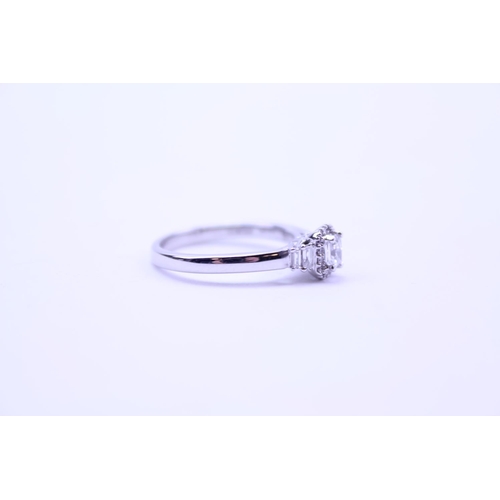 219 - A Ladies 18ct White Gold Ring set with a Radiant Cut Diamond with Diamond Chips and shoulders comple... 