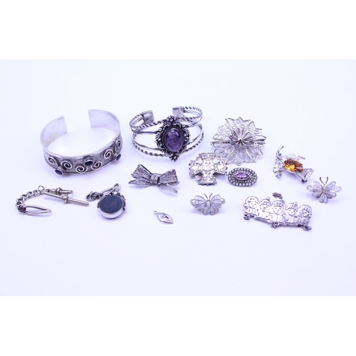 146 - A collection of various Silver items to include an albert fob along with brooches.