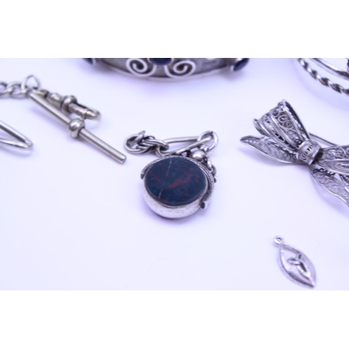 146 - A collection of various Silver items to include an albert fob along with brooches.