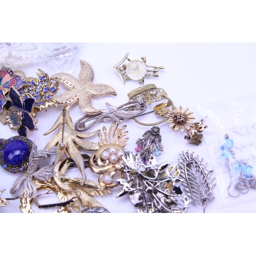 149 - A quantity of costume jewellery to include badges, brooches, etc.