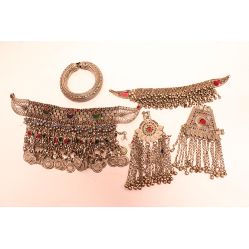 877 - A Tibetan bangle, a glass inset chest necklace along with similar other items.