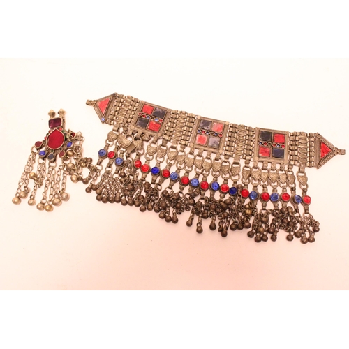 882 - A heavy Tibetan metal necklace along with a similar pendant.