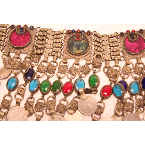 884 - A Tibetan metal necklace hung with coins and a hanging attachment.